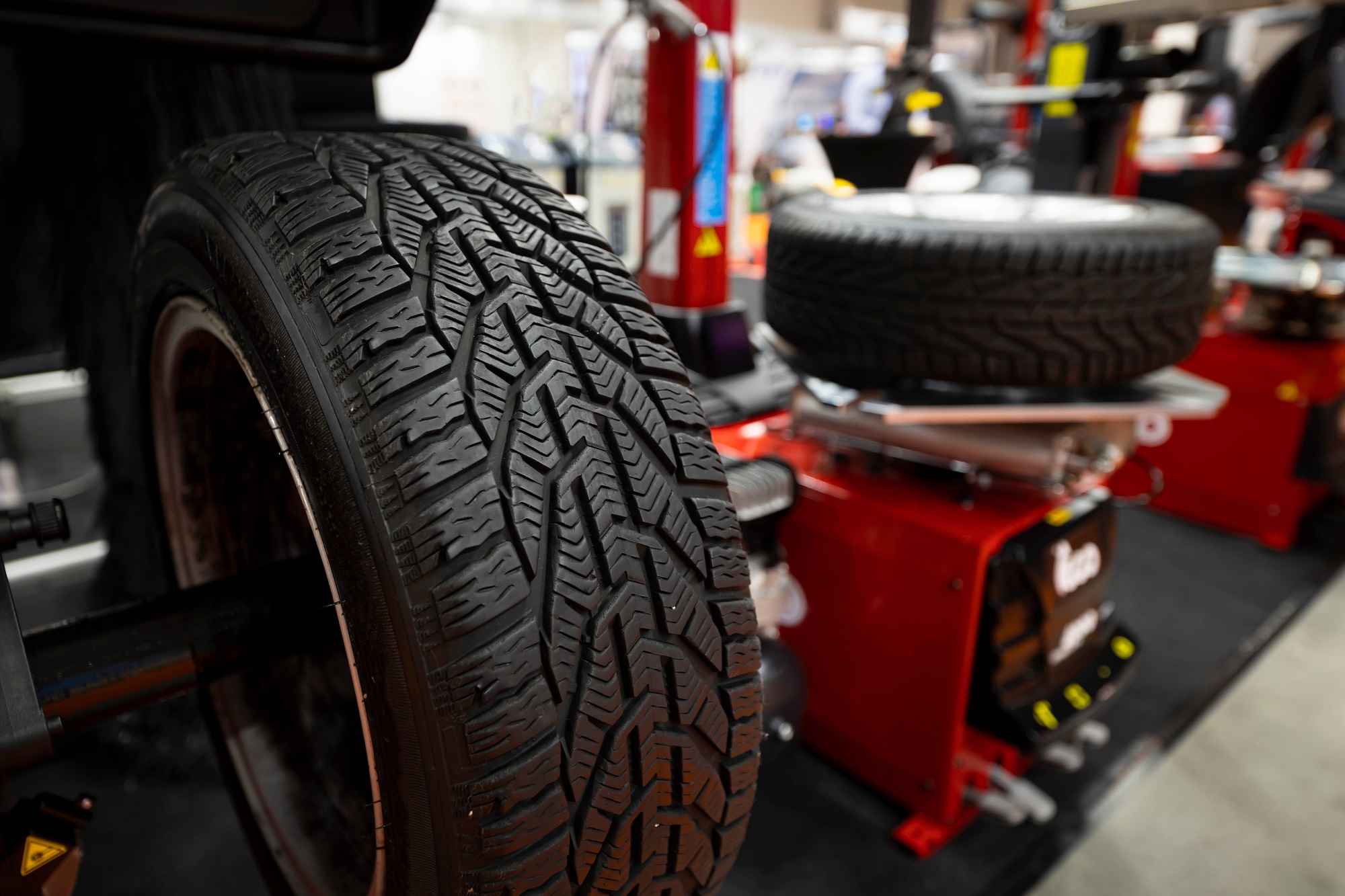 Professional tire installation with tire balancing equipment in auto repair shop
